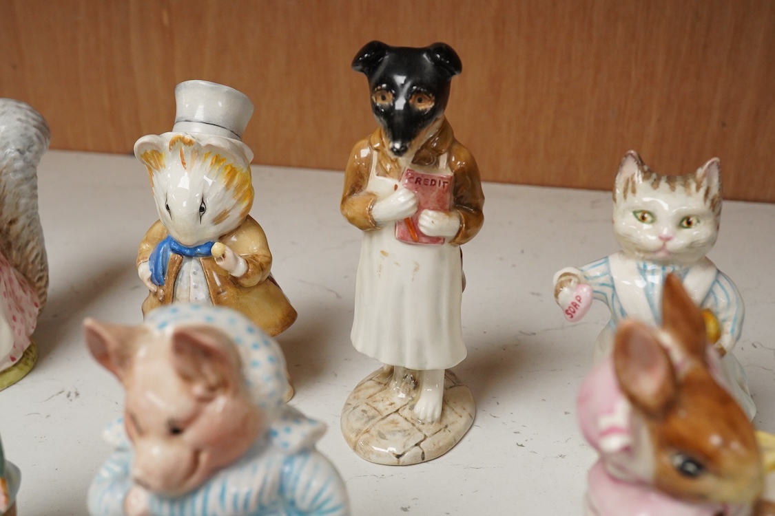 A collection of thirteen Beatrix Potter character figures, stamped with a gold stamp F Warn and Co Ltd, Beswick England, largest 12cm high